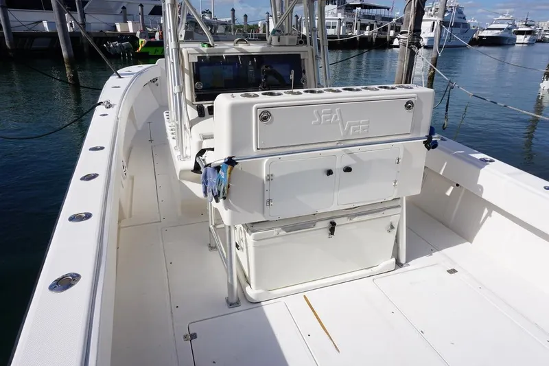 Slide: The Image of 2006 SeaVee 340i Open boat interior, featuring helm station and storage, docked at marina. - 6