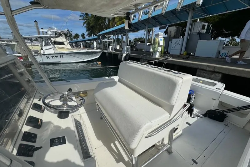 Slide: The Image of 2006 SeaVee 340i Open boat interior at dock, featuring steering wheel and seating. - 7