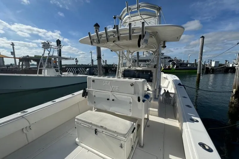 Slide: The Image of 2006 SeaVee 340i Open boat docked, featuring spacious deck and fishing equipment. - 9