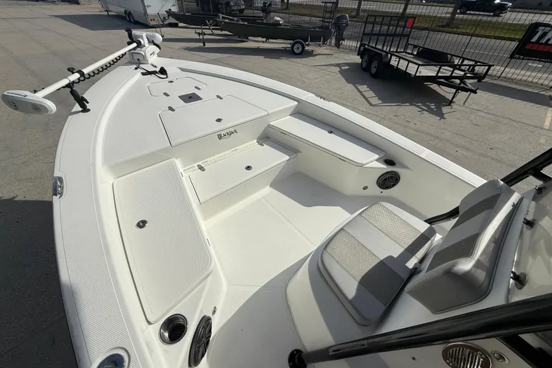 Slide: The Image of 2009 BlackJack 224 boat interior with seating and storage compartments. - 10