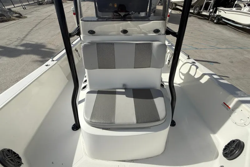 Slide: The Image of 2009 BlackJack 224 boat interior with cushioned seating and console. - 12