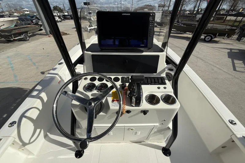 Slide: The Image of 2009 BlackJack 224 boat console with steering wheel, gauges, and navigation system. - 15