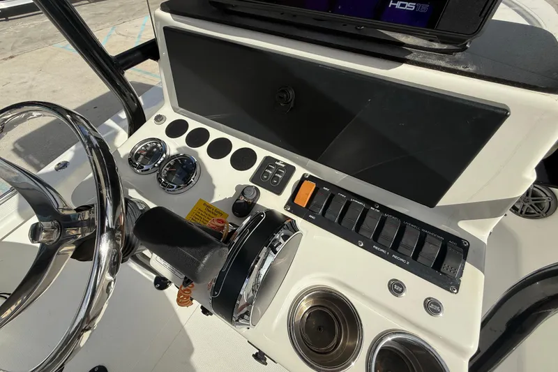 Slide: The Image of 2009 BlackJack 224 boat dashboard with steering wheel and control panel. - 17