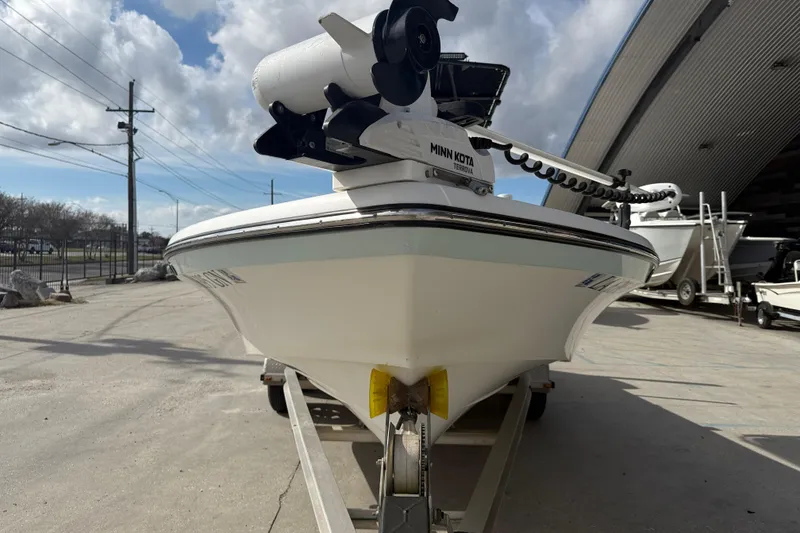 Slide: The Image of 2009 BlackJack 224 boat with Minn Kota motor on trailer, outdoor setting. - 3