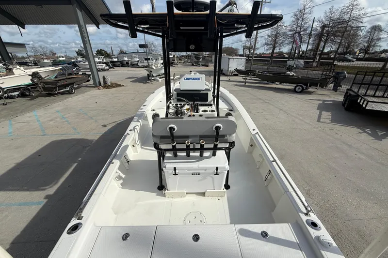 Slide: The Image of 2009 BlackJack 224 boat with center console, parked outdoors in a marina. - 8