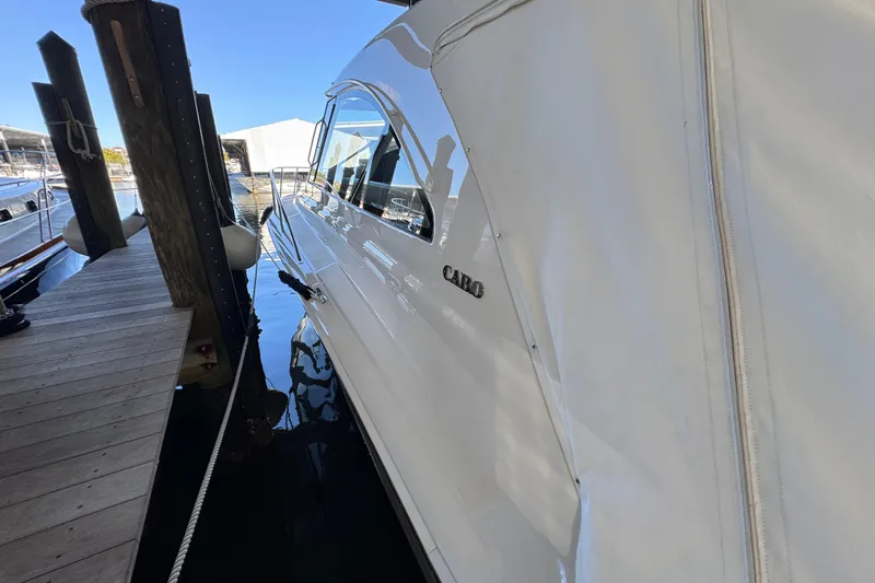 Slide: The Image of 2013 Cabo 44 Hardtop Express yacht docked at marina. - 24