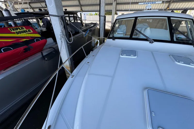 Slide: The Image of 2013 Cabo 44 Hardtop Express yacht docked in marina, side view. - 29