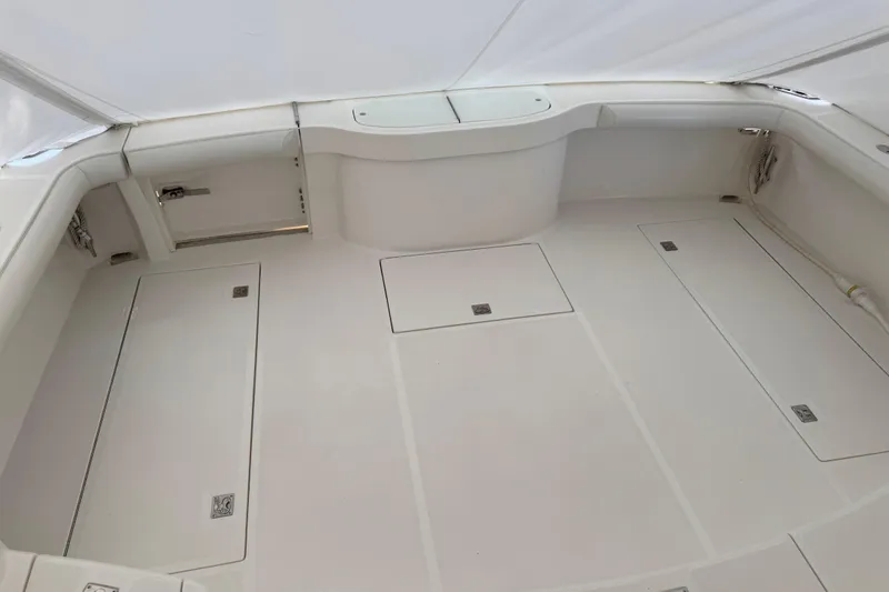 Slide: The Image of 2013 Cabo 44 Hardtop Express boat interior with spacious, clean deck layout. - 33