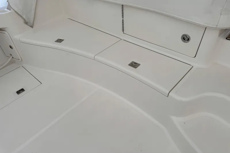 Slide: The Image of 2013 Cabo 44 Hardtop Express boat deck with storage compartments. - 37