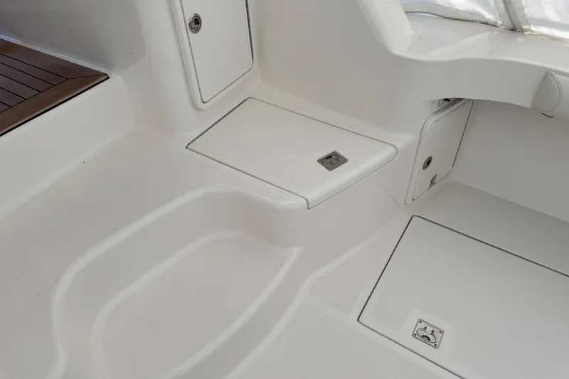 Slide: The Image of Interior view of 2013 Cabo 44 Hardtop Express boat, featuring sleek white surfaces. - 38