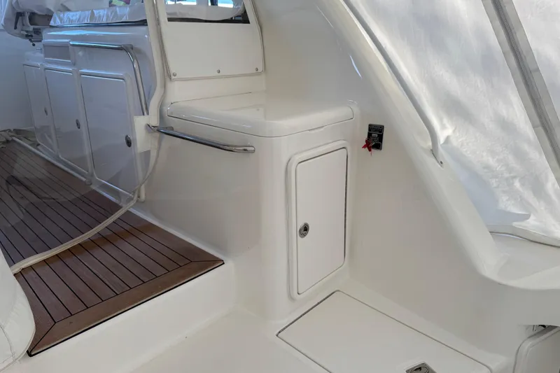 Slide: The Image of 2013 Cabo 44 Hardtop Express interior with sleek white cabinetry and wooden flooring. - 40