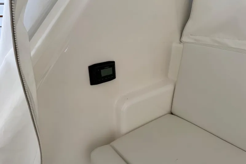 Slide: The Image of Interior of 2013 Cabo 44 Hardtop Express with white seating and control panel. - 42