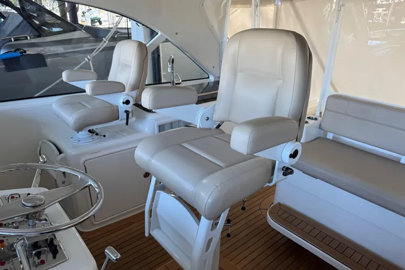 Slide: The Image of Luxurious interior of 2013 Cabo 44 Hardtop Express yacht with plush seating and steering wheel. - 45