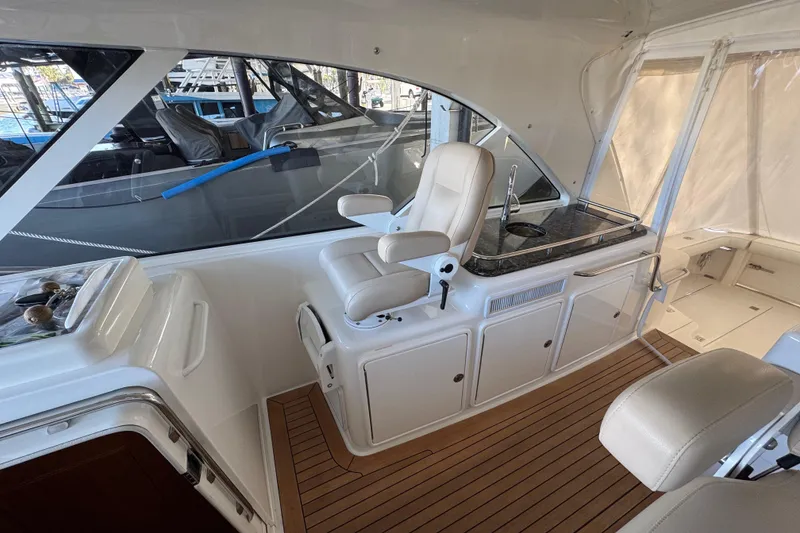 Slide: The Image of 2013 Cabo 44 Hardtop Express interior with helm seat and sleek design. - 46