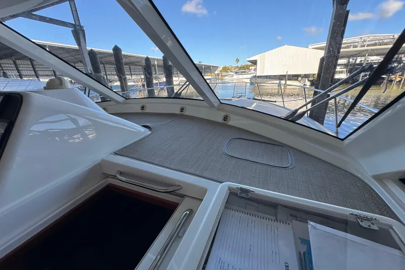 Slide: The Image of Interior view of 2013 Cabo 44 Hardtop Express yacht with marina backdrop. - 48