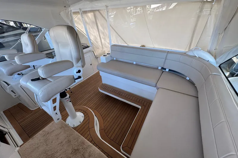 Slide: The Image of Luxurious interior of 2013 Cabo 44 Hardtop Express yacht with plush seating and wood flooring. - 49