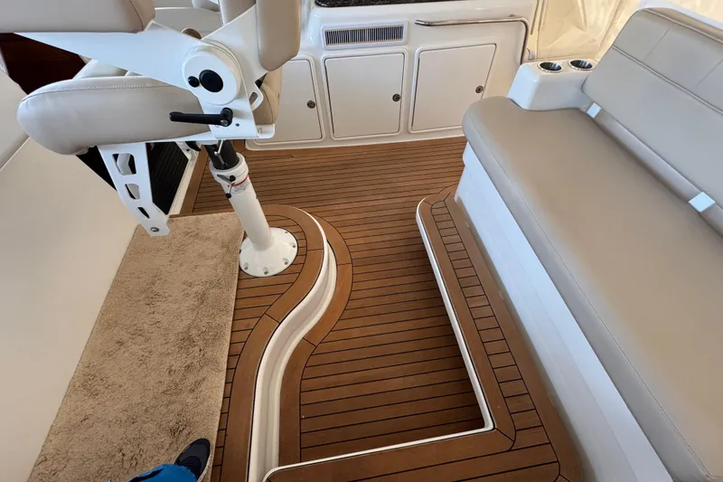 Slide: The Image of Interior of 2013 Cabo 44 Hardtop Express with teak flooring and beige seating. - 50