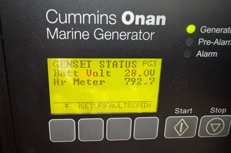 Slide: The Image of Cummins Onan marine generator display showing battery voltage and hour meter for Cabo 44 Hardtop Express. - 54
