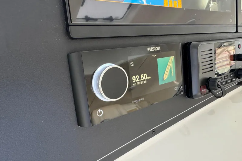 Slide: The Image of Control panel of 2013 Cabo 44 Hardtop Express with Fusion and Garmin displays. - 59