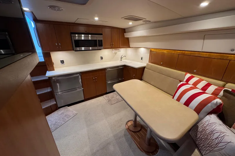 Slide: The Image of Luxurious interior of 2013 Cabo 44 Hardtop Express yacht with modern kitchen and cozy seating. - 61