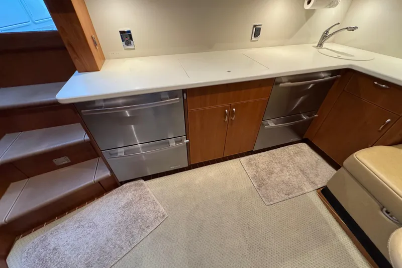 Slide: The Image of Modern kitchen area in a 2013 Cabo 44 Hardtop Express yacht with stainless steel appliances. - 63
