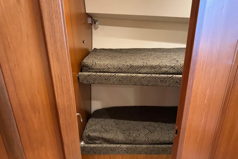 Slide: The Image of Bunk beds inside 2013 Cabo 44 Hardtop Express yacht with patterned cushions. - 66