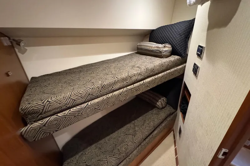 Slide: The Image of Bunk beds in 2013 Cabo 44 Hardtop Express yacht cabin with patterned bedding. - 69