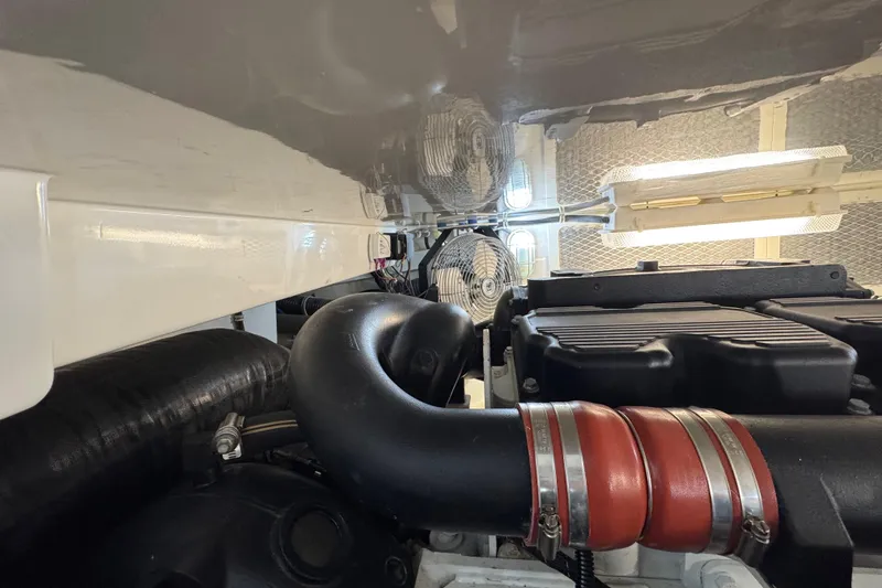 Slide: The Image of Engine room of 2013 Cabo 44 Hardtop Express with visible components and ventilation system. - 81