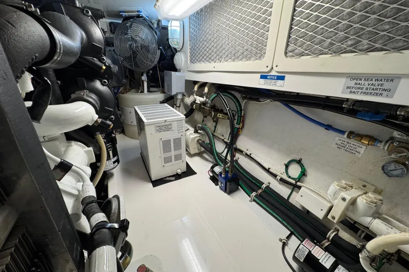 Slide: The Image of Engine room of 2013 Cabo 44 Hardtop Express with machinery and wiring. - 84