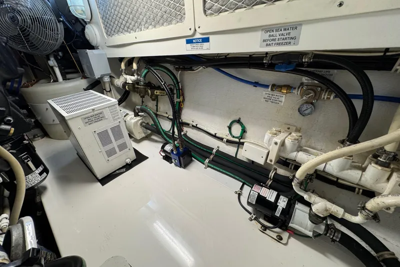 Slide: The Image of Engine room of 2013 Cabo 44 Hardtop Express with various mechanical components and wiring. - 85