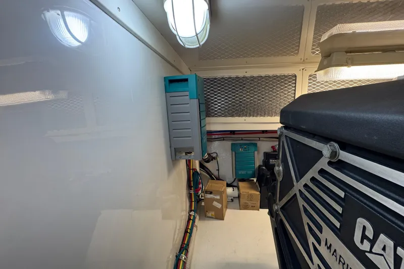 Slide: The Image of Engine room of 2013 Cabo 44 Hardtop Express with electrical equipment and wiring. - 87