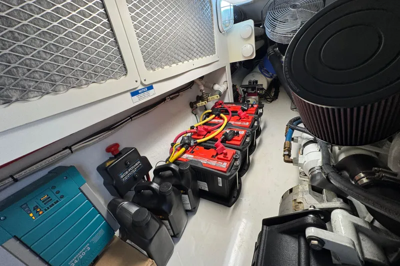 Slide: The Image of Engine room of 2013 Cabo 44 Hardtop Express with batteries and equipment. - 88