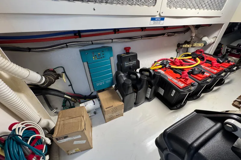 Slide: The Image of Engine room of 2013 Cabo 44 Hardtop Express with batteries and equipment. - 90