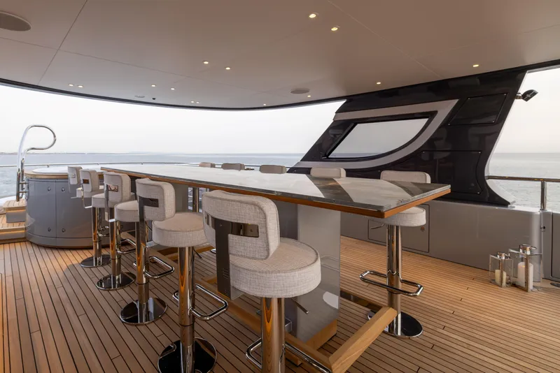 Slide: The Image of Luxurious 2024 Benetti Oasis 34M yacht deck with elegant bar seating and ocean view. - 11