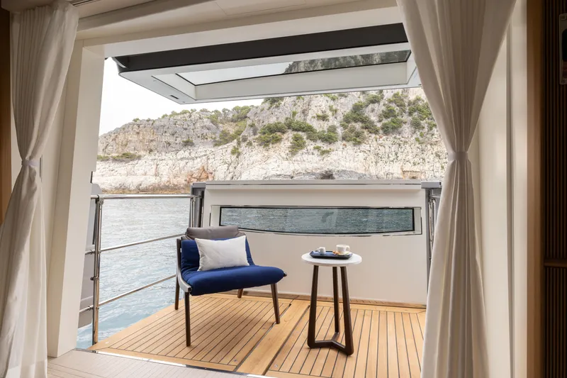 Slide: The Image of Luxurious deck view from 2024 Benetti Oasis 34M yacht, featuring elegant seating and scenic coastal backdrop. - 25