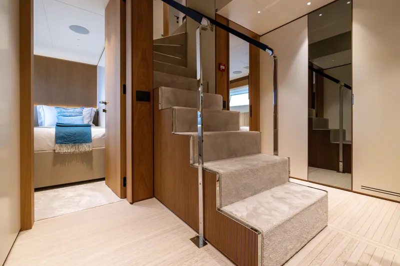 Slide: The Image of Luxurious interior of 2024 Benetti Oasis 34M yacht, featuring elegant staircase and cozy bedroom. - 35