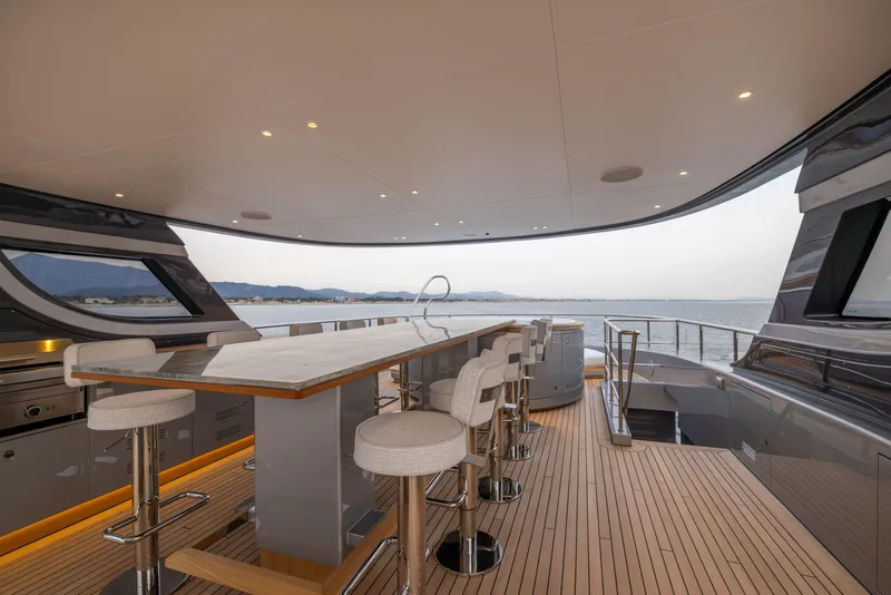 Slide: The Image of Luxurious 2024 Benetti Oasis 34M yacht deck with bar and ocean view. - 13