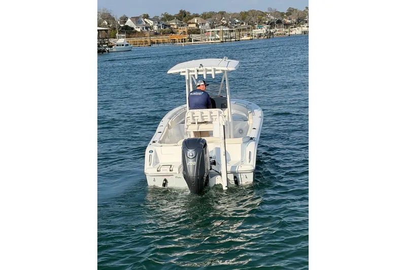 Slide: The Image of 2025 Sea Hunt Ultra 229 boat cruising on a calm waterway. - 12