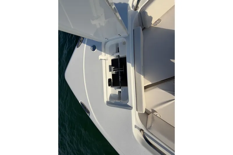 Slide: The Image of 2025 Sea Hunt Ultra 229 boat deck with open storage compartment. - 21
