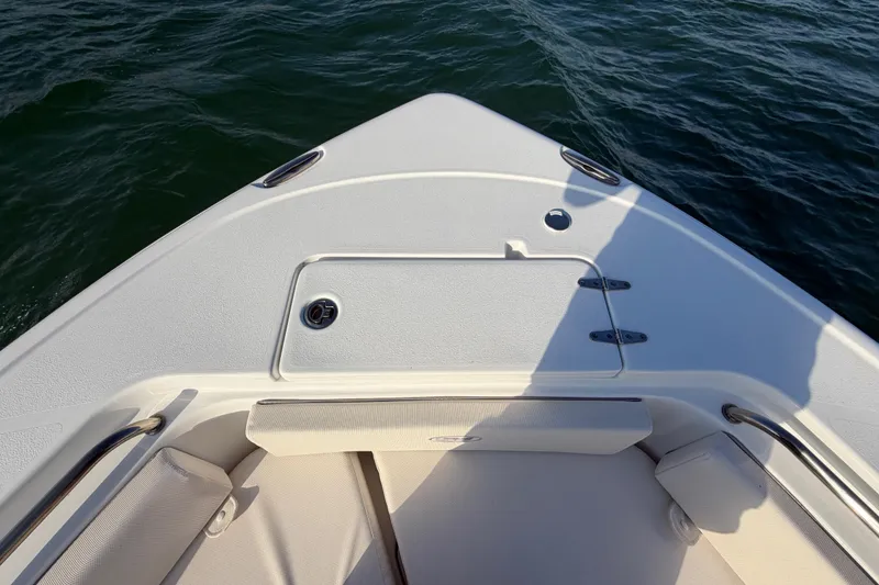 Slide: The Image of Bow of 2025 Sea Hunt Ultra 229 boat on water, featuring sleek design and seating. - 22