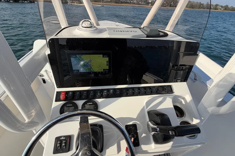 Slide: The Image of 2025 Sea Hunt Ultra 229 boat dashboard with navigation system and controls. - 29