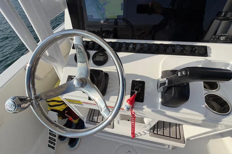 Slide: The Image of Steering console of 2025 Sea Hunt Ultra 229 boat with navigation controls and display. - 39