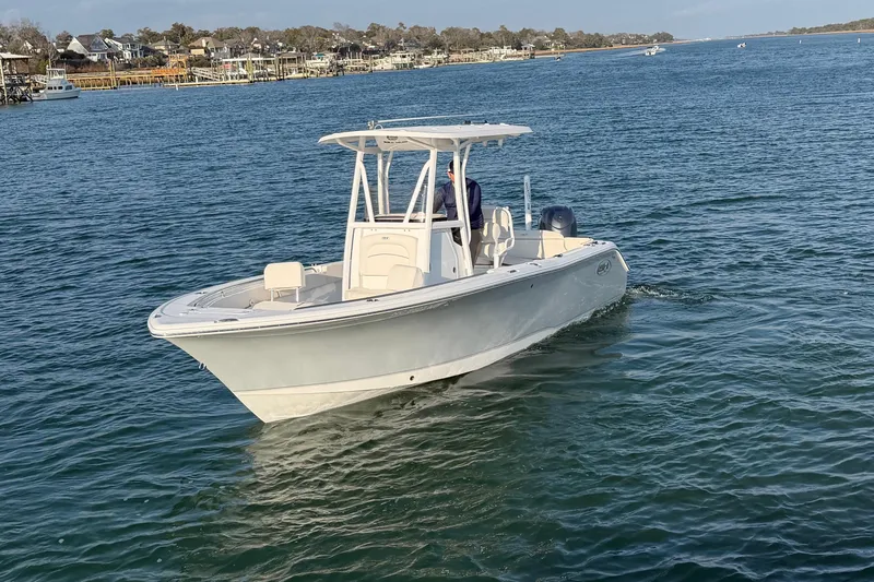 Slide: The Image of 2025 Sea Hunt Ultra 229 boat cruising on a calm blue sea. - 43