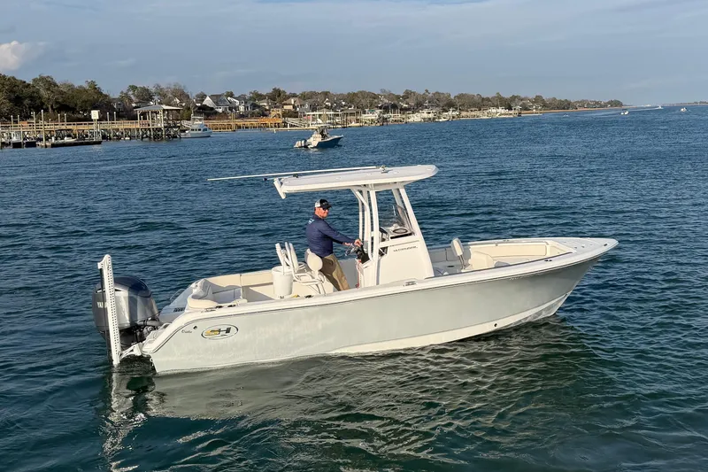 Slide: The Image of 2025 Sea Hunt Ultra 229 boat cruising on a calm blue sea. - 46
