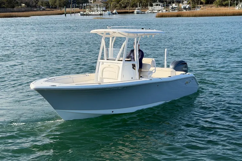 Slide: The Image of 2025 Sea Hunt Ultra 229 boat cruising on calm waters. - 6