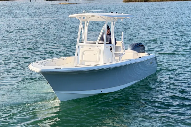 Slide: The Image of 2025 Sea Hunt Ultra 229 boat cruising on open water. - 7