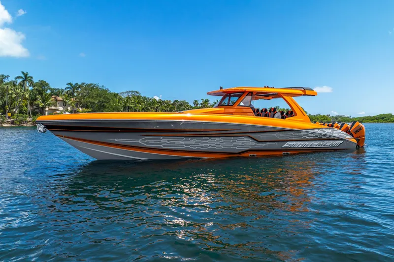 The Image of Orange and gray 2025 Statement 44 GRTS boat on water, clear blue sky. - 1