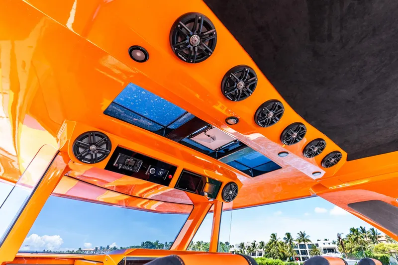 Slide: The Image of Orange interior of 2025 Statement 44 GRTS boat with speakers and skylight. - 43