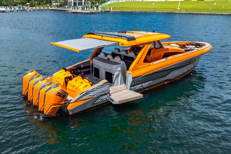 Slide: The Image of 2025 Statement 44 GRTS boat with vibrant orange design and powerful engines on water. - 13