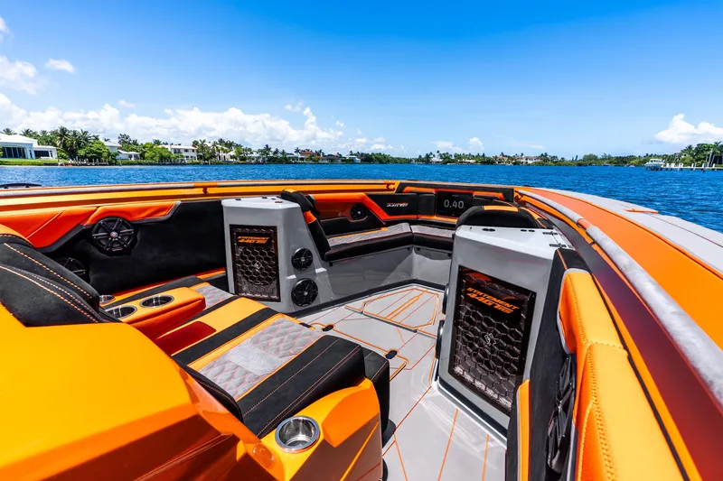 Slide: The Image of Luxurious 2025 Statement 44 GRTS boat interior with vibrant orange seating on a sunny day. - 25